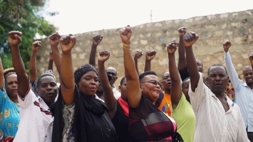 A group of women striving to build civic power raise their fists
