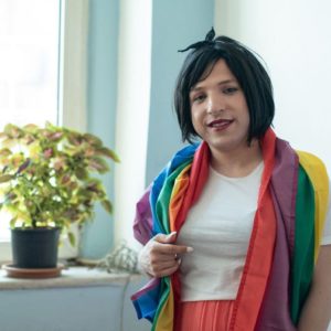 A portrait of Altaf wearing a rainbow flag. She is a leading grassroots activist supporting migrants in Turkey