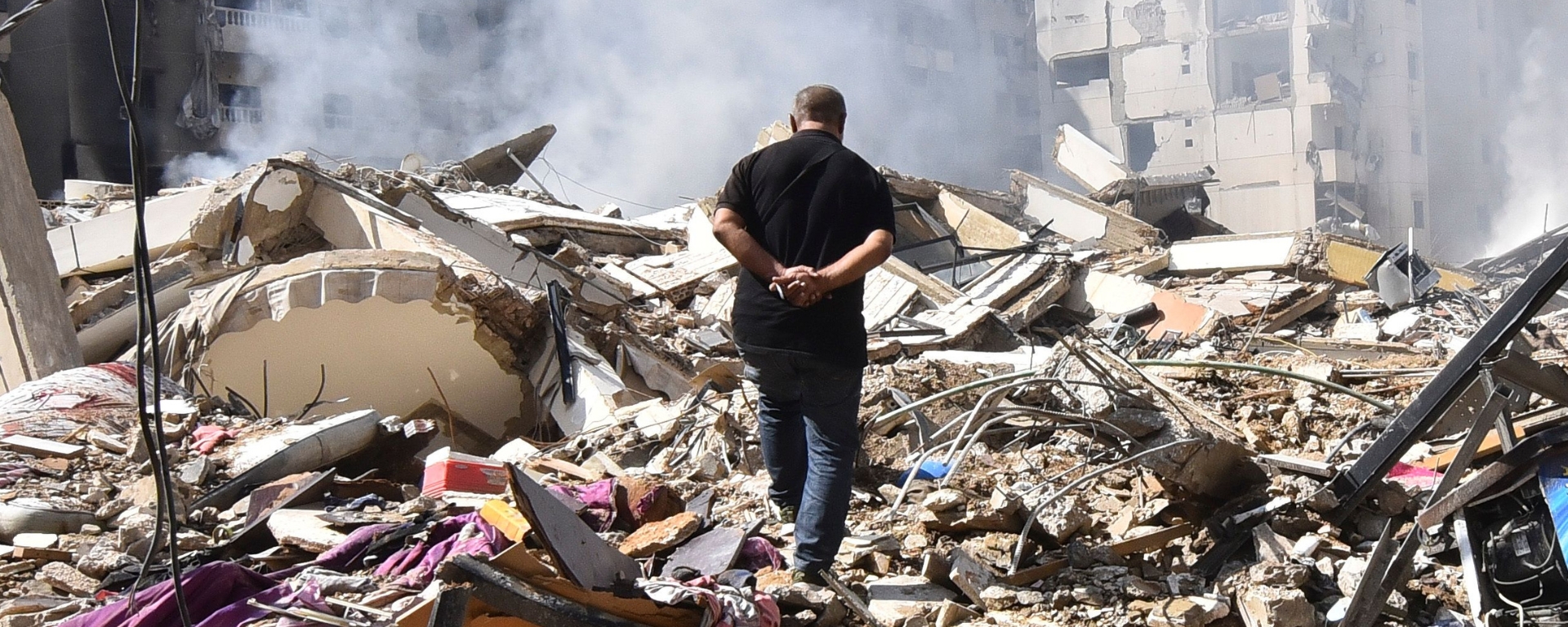 During the Lebanon conflict, a man walks through the ruins of a destroyed building. Donate to Lebanon crisis appeal to support refugees and human rights in Lebanon and beyond.